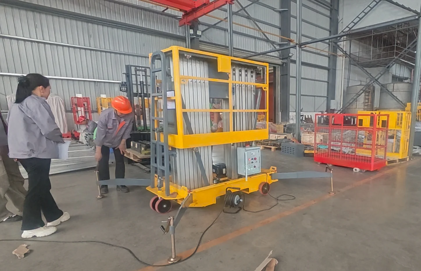 QC engineer performing rated load test on completed scissor lift