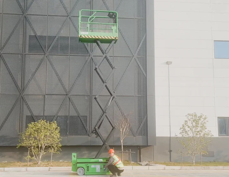 Self-propelled scissor lift MX series operating in warehouse aisle at full height