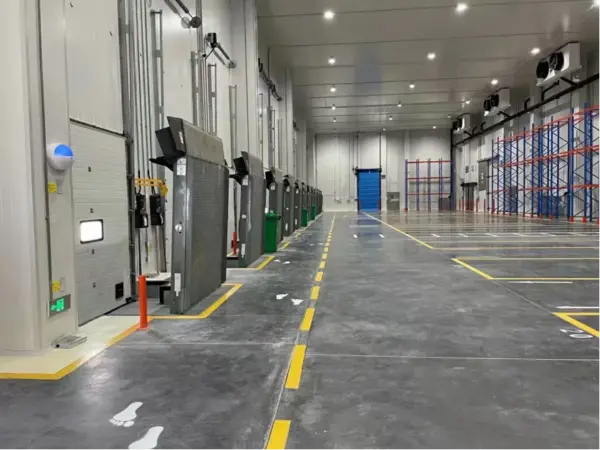 Cold-store loading bay with dock leveller, industrial door and dock shelter
